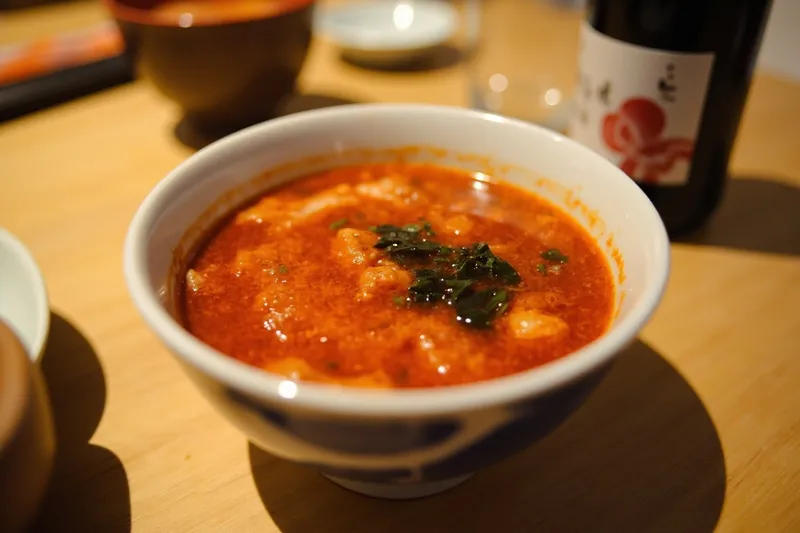 Bowl of miso soup with wakame on a restaurant table