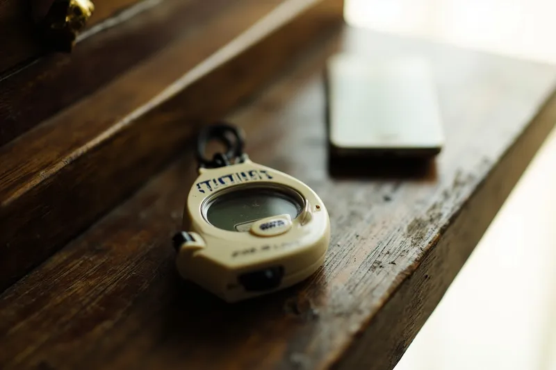 Vintage Japanese step-counter pedometer on a wooden desk